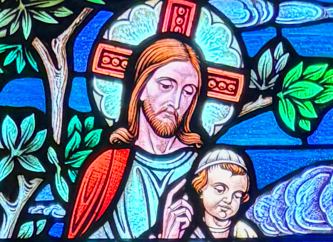 Stained glass -vitral- with the image of Jesus and a child.